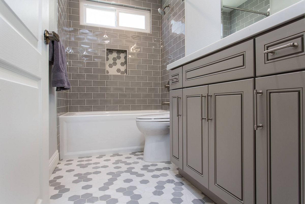 Transitional-style-bathroom-vanity-in-gray-along-with-white-and-gray-hexagonal-floor-tiles