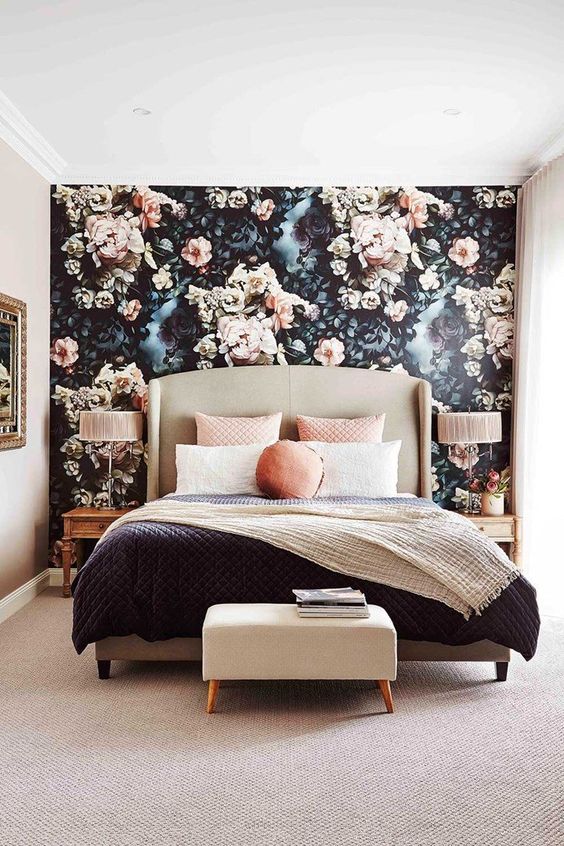 A-chic-bedroom-with-a-dark-floral-accent-wall-and-a-blanket-and-throws-to-match-its-colors