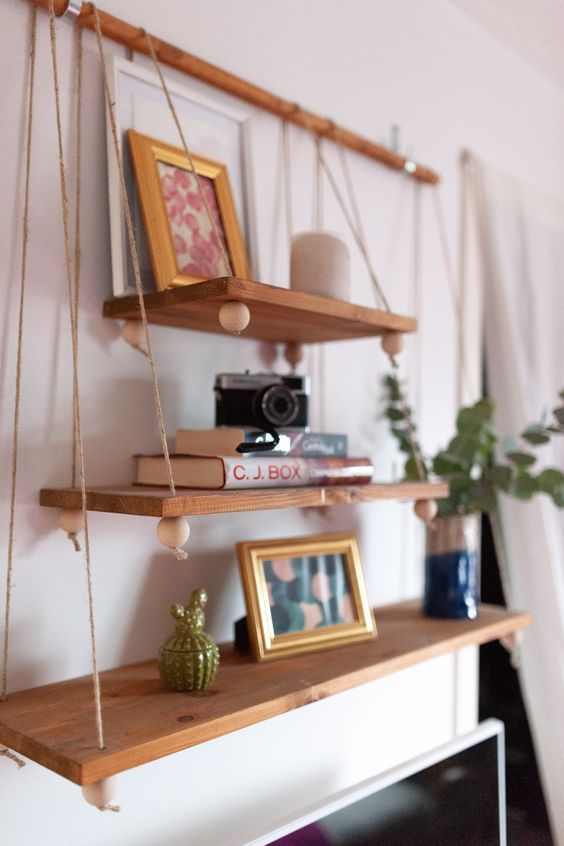 12-a-boho-hanging-shelf-composed-of-several-tiers-of-various-sizes-beads-on-a-wooden-holder