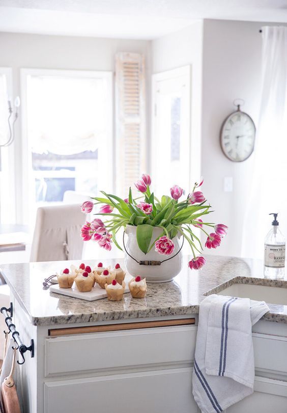 A-large-white-porcelain-jar-with-bright-pink-tulips-is-a-bold-spring-centerpiece-that-looks-fresh-and-romantic
