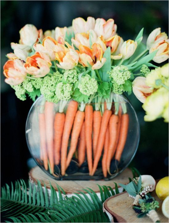 A-round-aquarium-with-frehs-carrots-and-matching-orange-tulips-is-a-bold-spring-or-easter-decoration